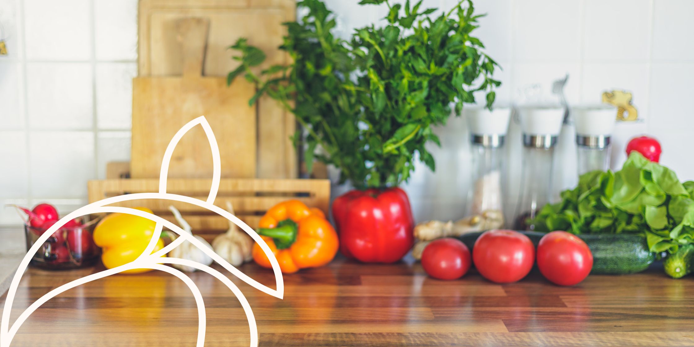 Brightly colored vegetables are set out on a wooden kitchen counterop.
