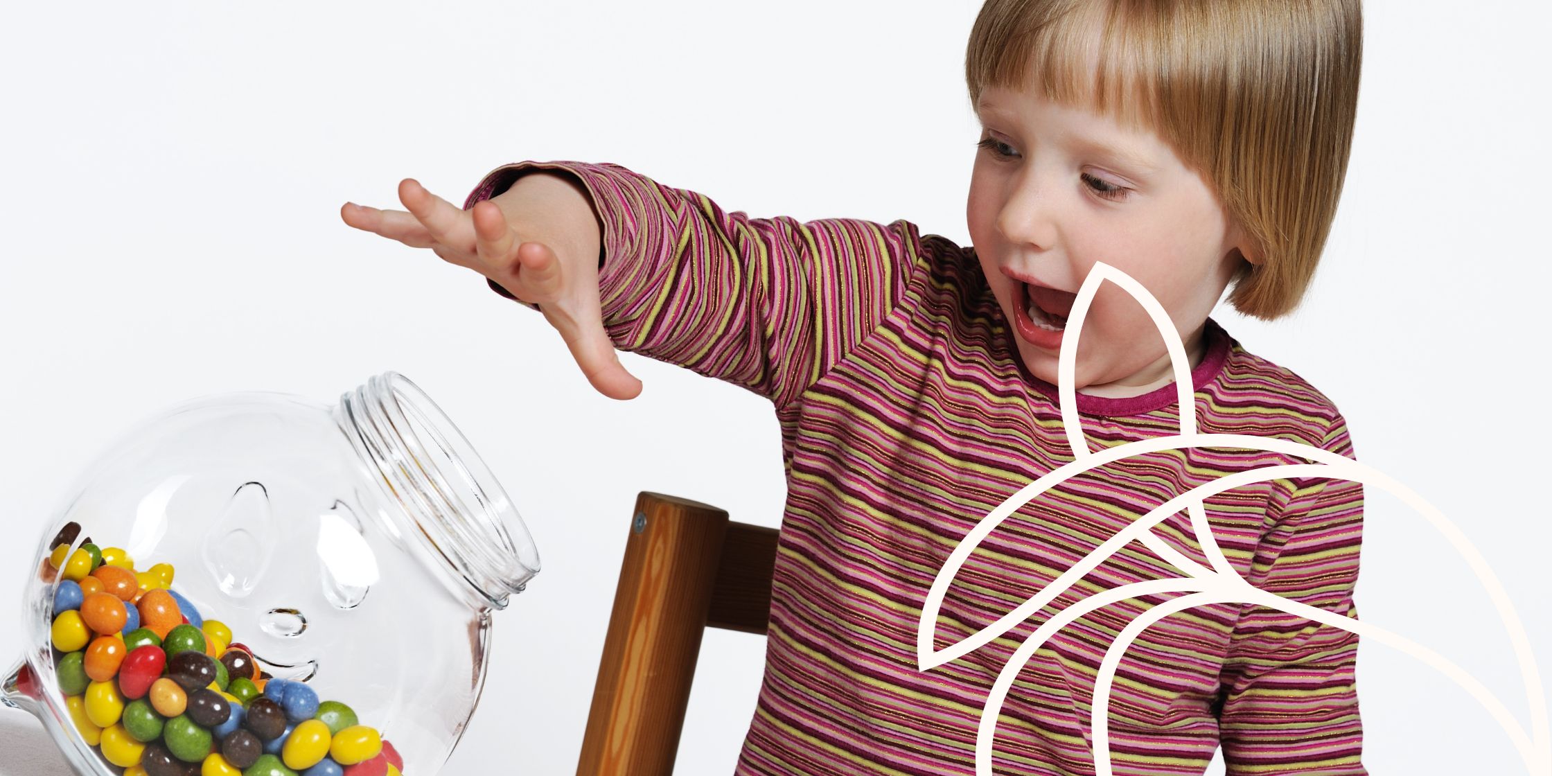A young boy's hand reaching into a jar filled with brightly colored candy, capturing a moment of childhood curiosity.