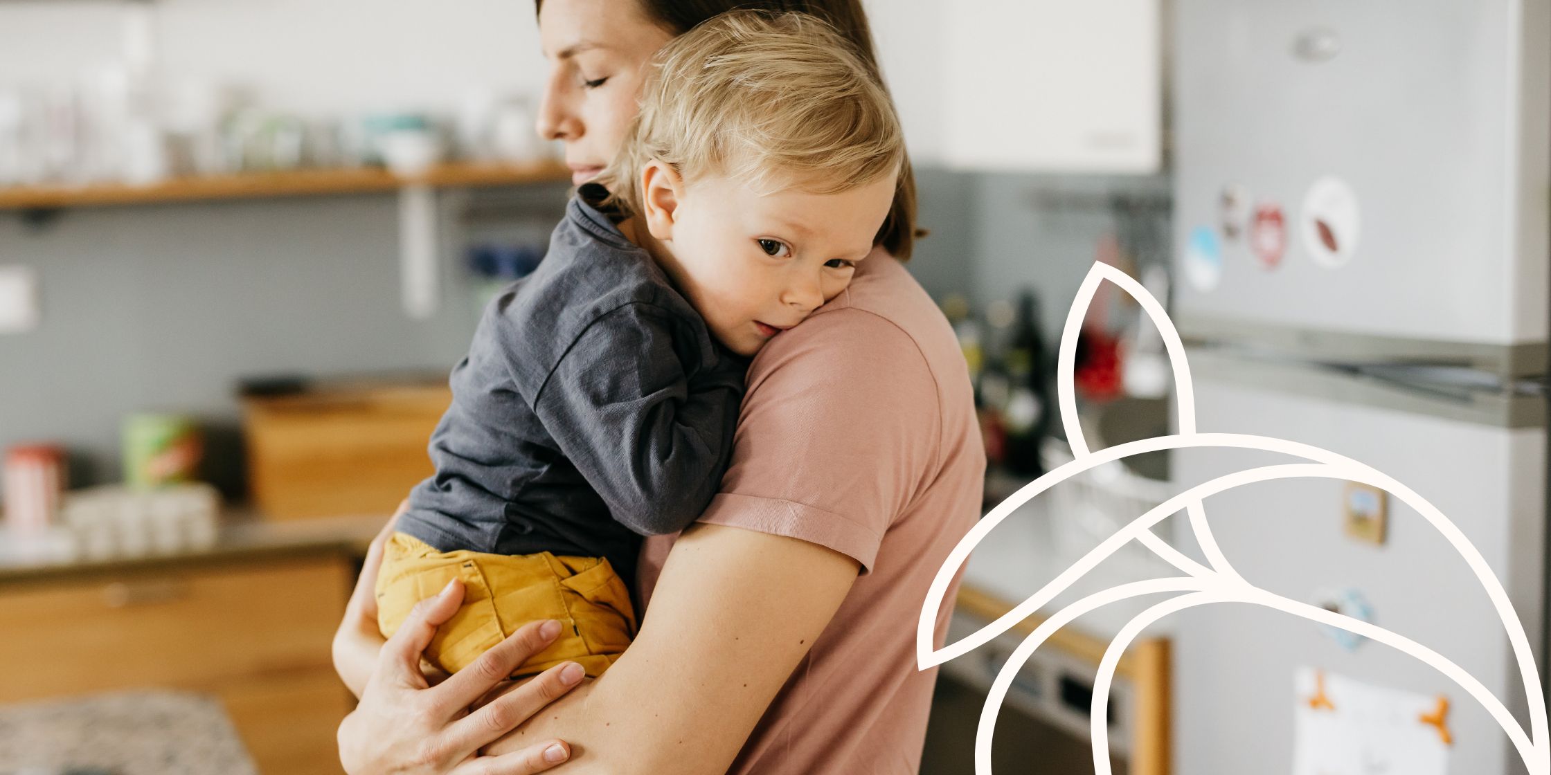 A mother takes a quiet, thankful moment in the kitchen holding her toddler son.